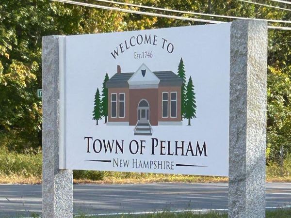 White wood sign with words Welcome to the Town of Pelham