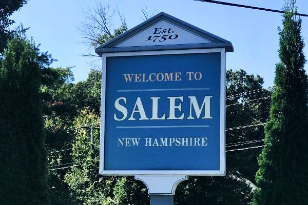 Blue wood sign with words Welcome to Salem