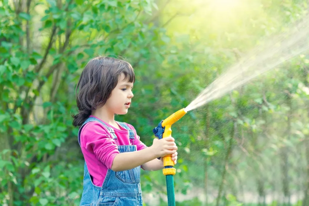 girl spraying water from a hose